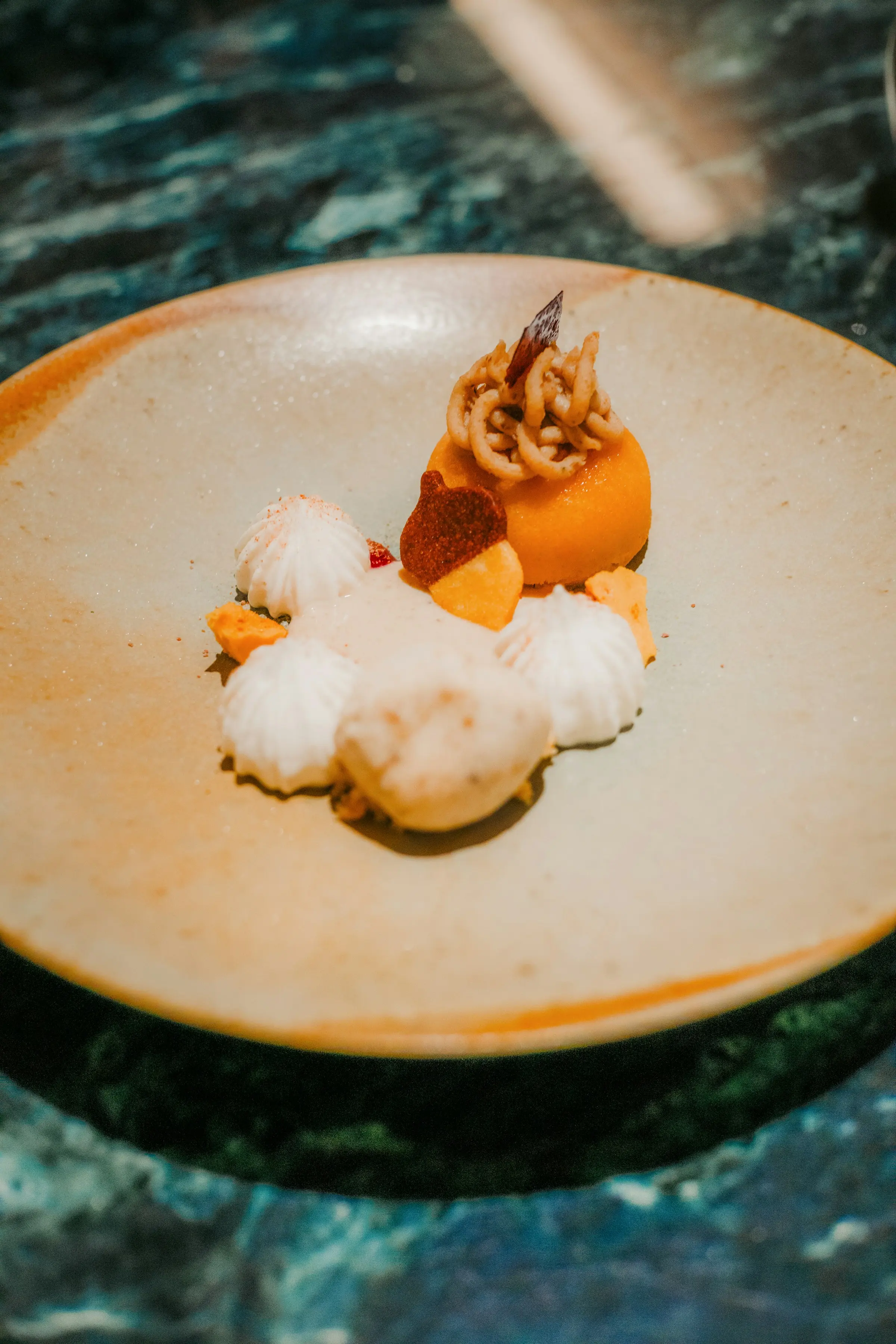 Meringue and fruit dessert on a ceramic plate