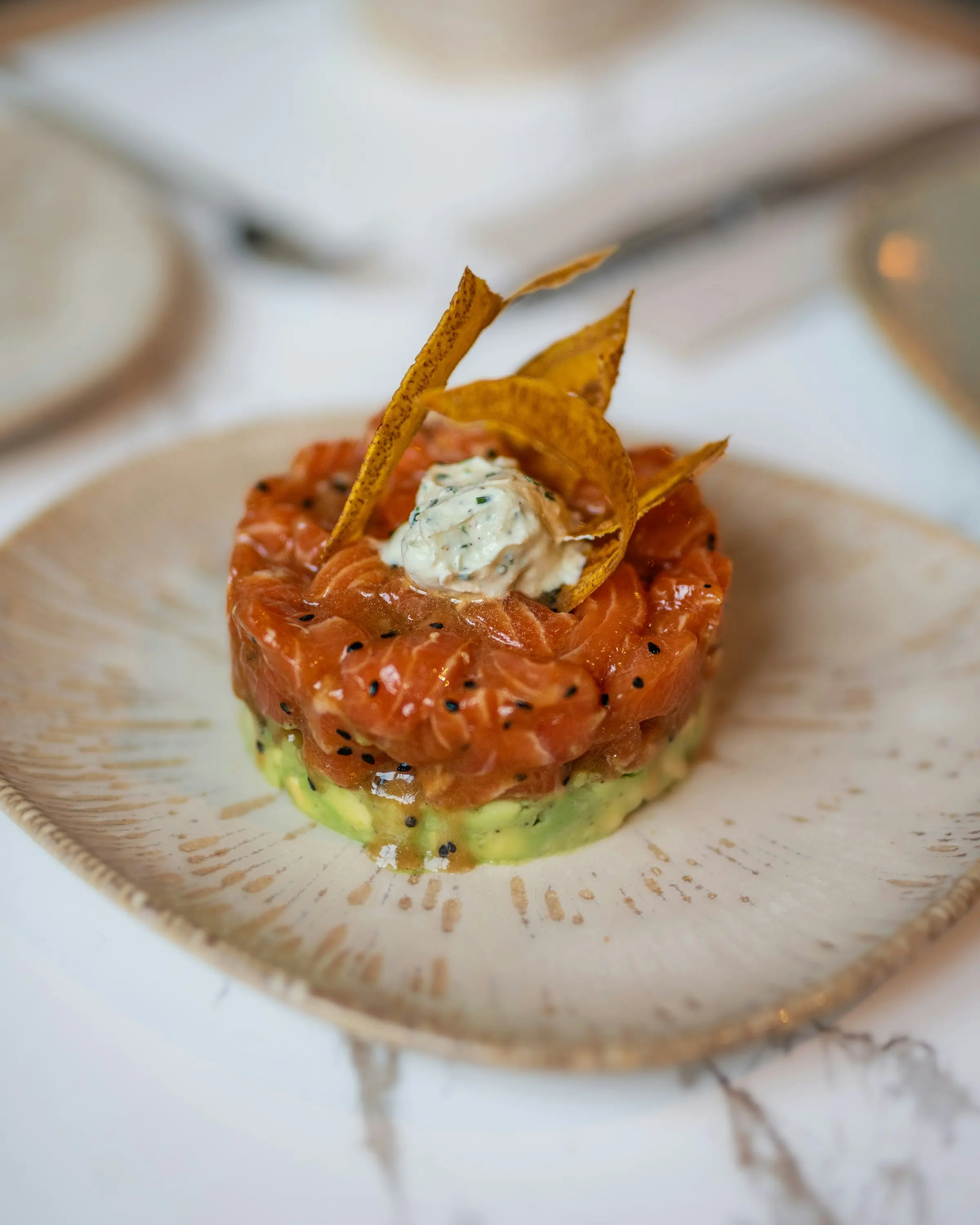 Salmon tartare tower with avocado and a crisp tuile